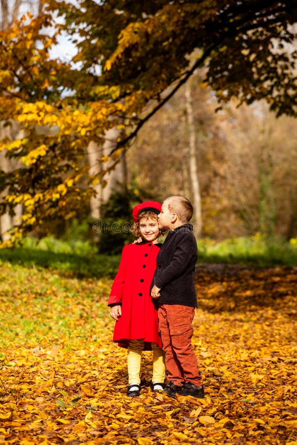 Friends play in a beautiful autumn park together royalty free stock photography