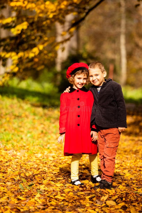 Friends play in a beautiful autumn park together stock images