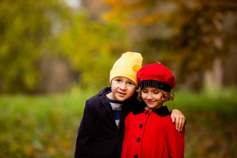 Friends play in a beautiful autumn park together royalty free stock photos