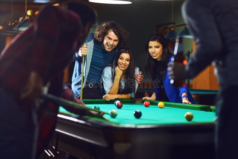 Friends play billiards., Stock image