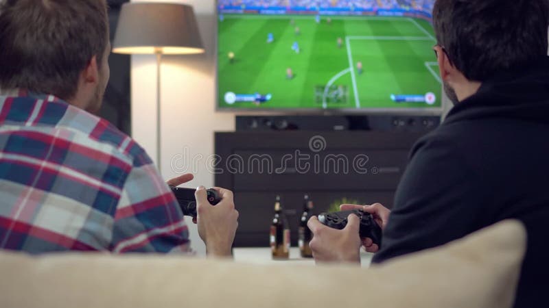Friends playing football on video game console