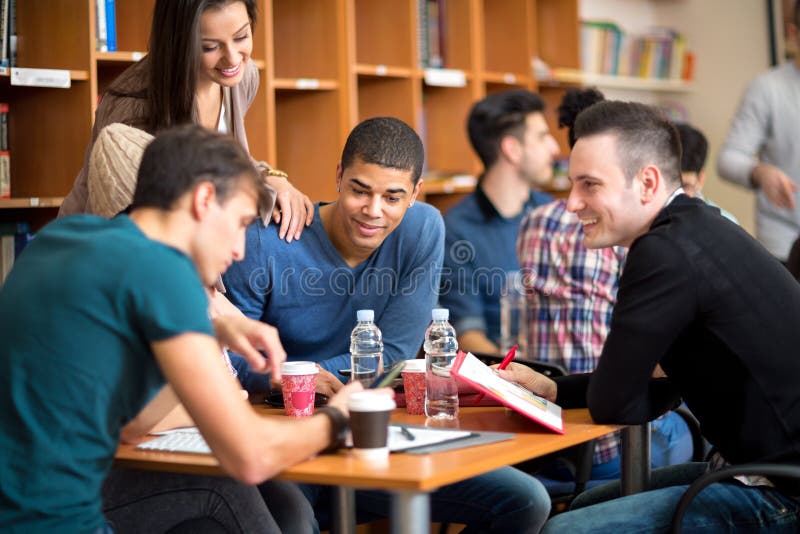 Friends socializing and studying together for exam