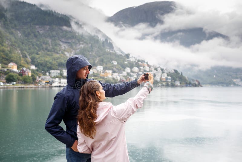 Friends take pictures of Selfie on the background of Odda, Norway