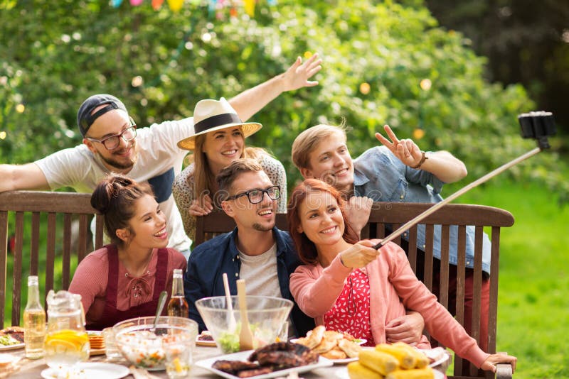 Friends taking selfie at party in summer garden