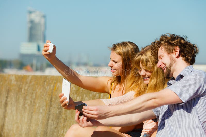 Friends taking selfie photo with smartphone royalty free stock photos Friends taking selfie photo with smartphone royalty free stock photos