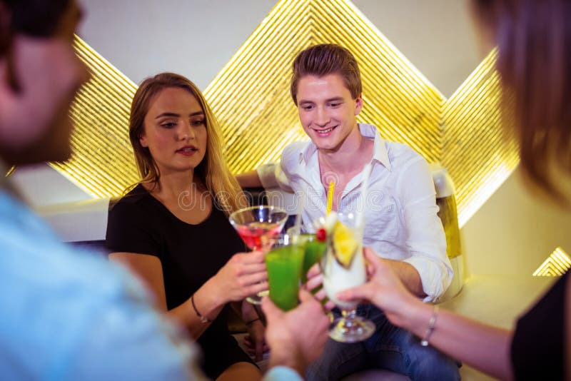 Friends toasting cocktail stock images