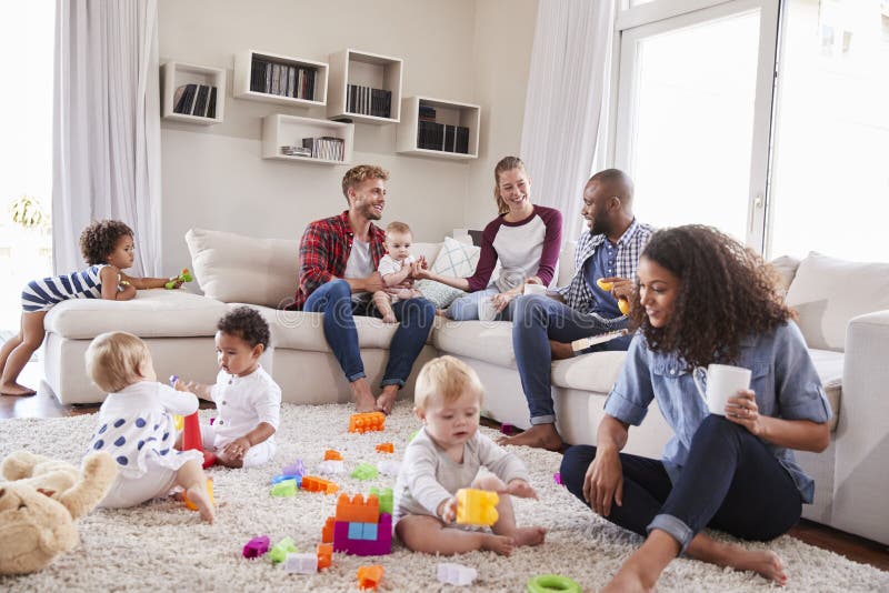 Friends with toddlers playing on the floor in sitting room. Happy multiethnic boys stock images, royalty-free photos and pictures
