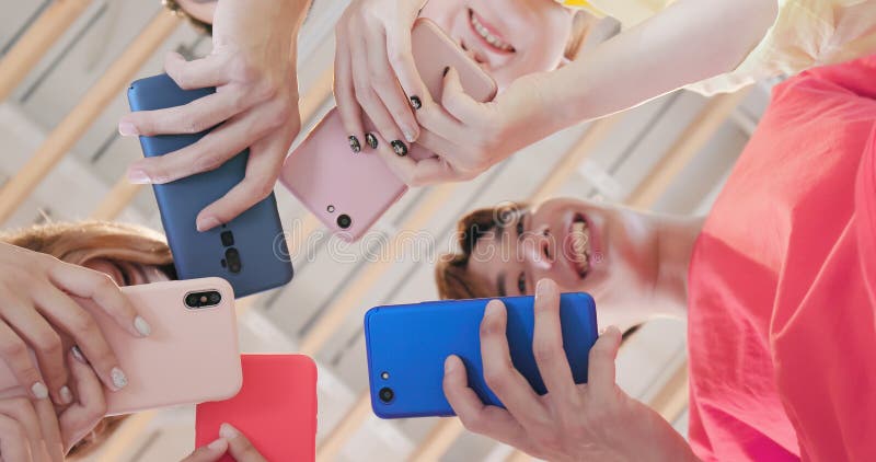 Friends use smart phone together stock photo