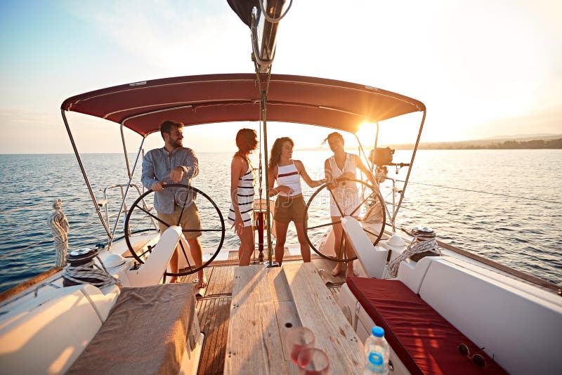 Friends on vacation travel on boat together and enjoy at summer day stock photography Friends on vacation travel on boat together and enjoy at summer day stock photography