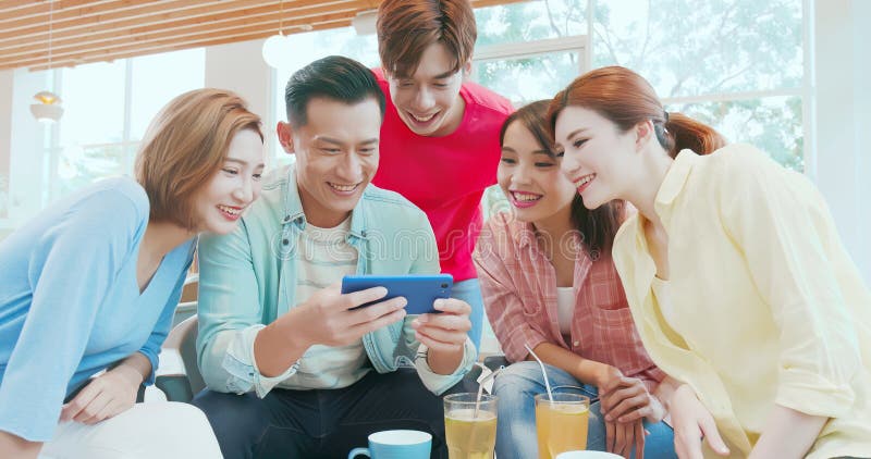 Friends watch video on phone stock image