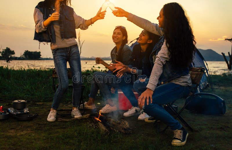 Friends of Young Asian women camping drinking beer party and cooking picnic together stock image Friends of Young Asian women camping drinking beer party and cooking picnic together stock image