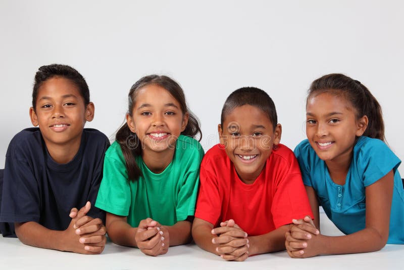 Friendship of four happy ethnic school children