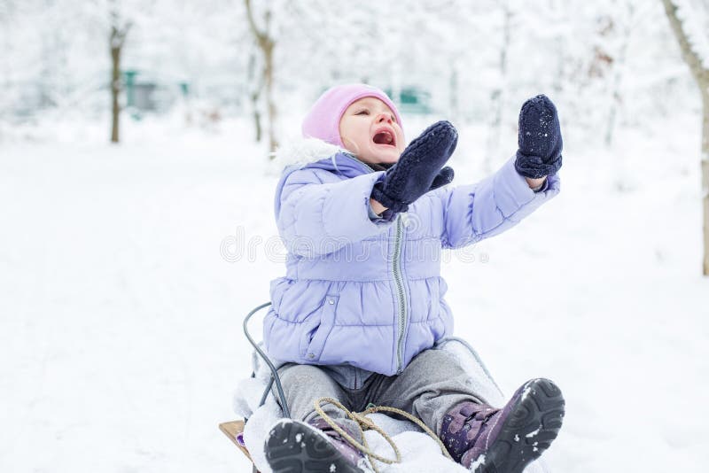 Winter clothes. Warm purple jacket and pink hat. Winter vacation. Healthy lifestyle. Winter clothes. Warm purple jacket and pink hat. Winter vacation. Healthy lifestyle