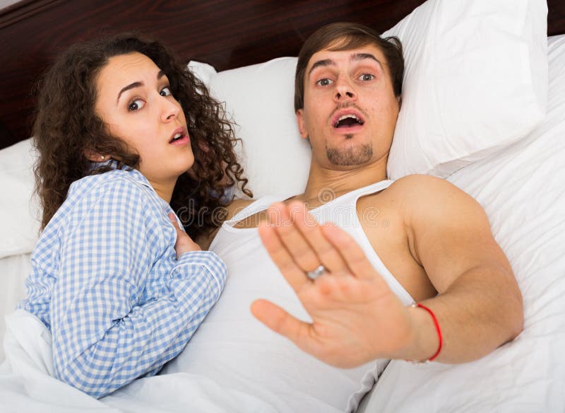 Young Wife with Lover Caught during Adultery Act Stock Photo