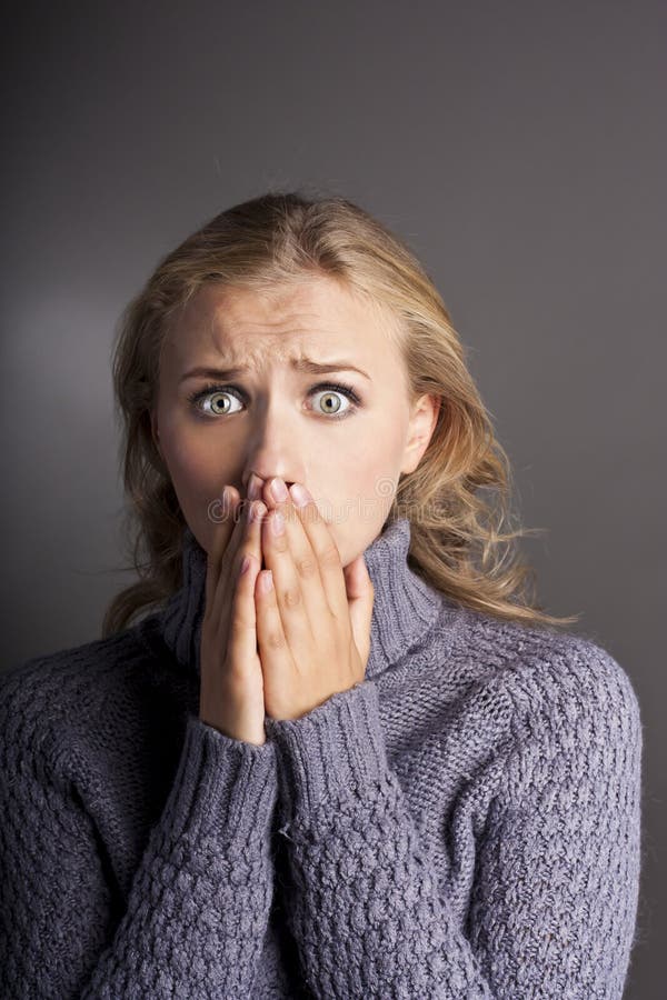 Frightened young woman in studio stock image