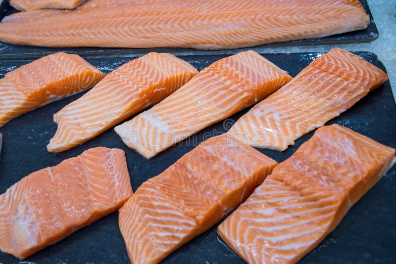 Frische Lachse Lachsfilets für Verkauf an einem Fischmarkt angezeigt mit einem Patchworkeffekt lizenzfreies stockfoto Frische Lachse Lachsfilets für Verkauf an einem Fischmarkt angezeigt mit einem Patchworkeffekt lizenzfreies stockfoto