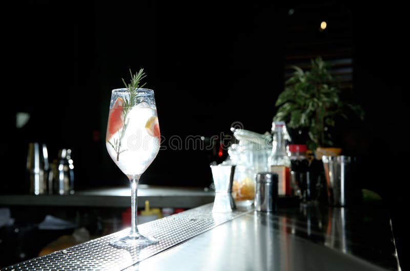 Frisches alkoholisches tonisches Cocktail des Pampelmusen- und Rosmaringins auf Barzähler stockbild Frisches alkoholisches tonisches Cocktail des Pampelmusen- und Rosmaringins auf Barzähler stockbild