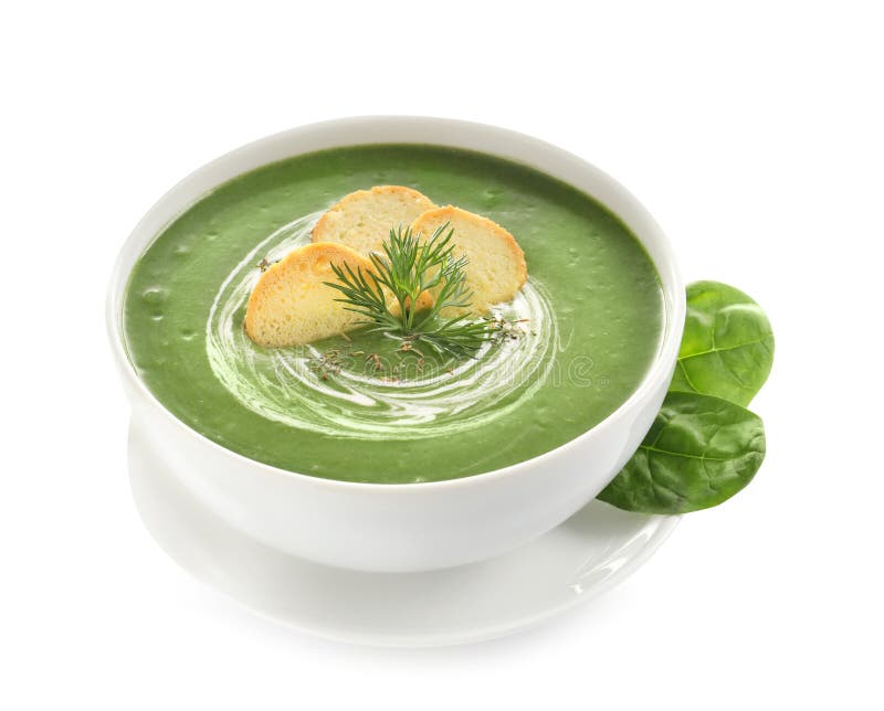 Frischgemüse Detoxsuppe gemacht vom Spinat mit Croutons im Teller und in den Blättern lizenzfreie stockfotos Frischgemüse Detoxsuppe gemacht vom Spinat mit Croutons im Teller und in den Blättern lizenzfreie stockfotos