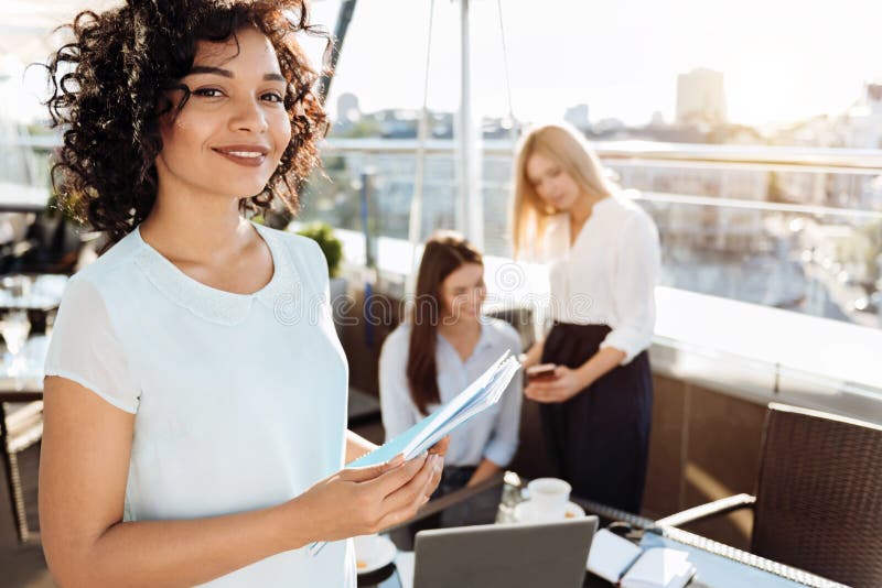 Frohe attraktive Frau, die Dokumente verwahrt stockbild Frohe attraktive Frau, die Dokumente verwahrt stockbild