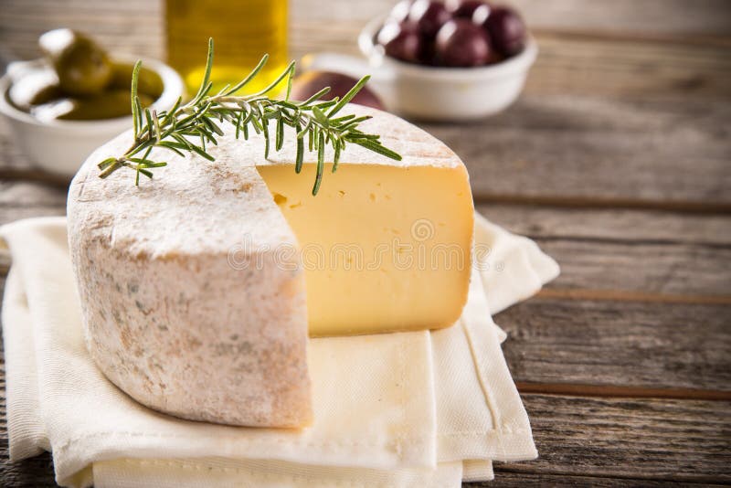 Delicious camembert cheese on old wooden table. Delicious camembert cheese on old wooden table