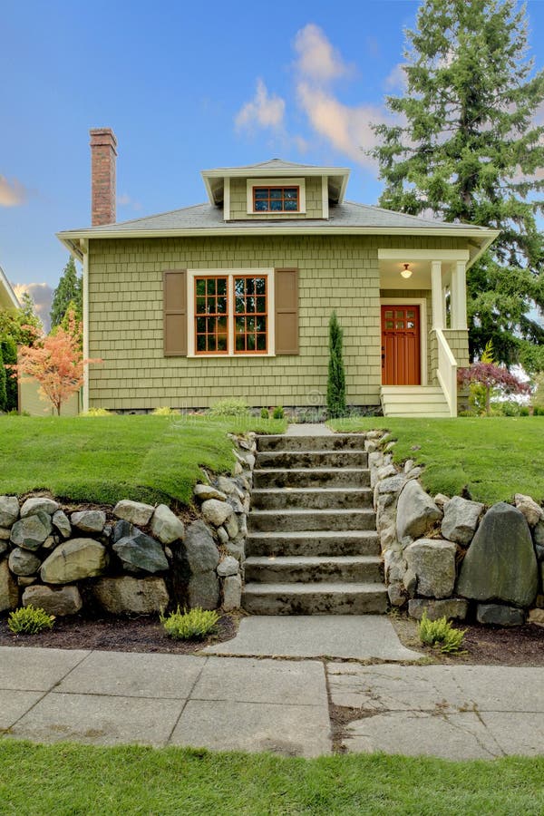 Front of the cute small green house with orage windows. Front of the cute small green house with orage windows