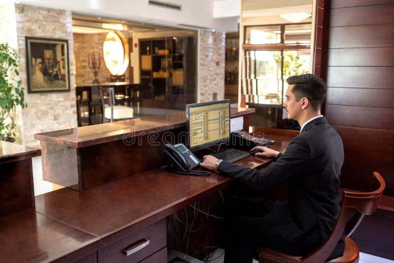 Front desk hotel receptionist working