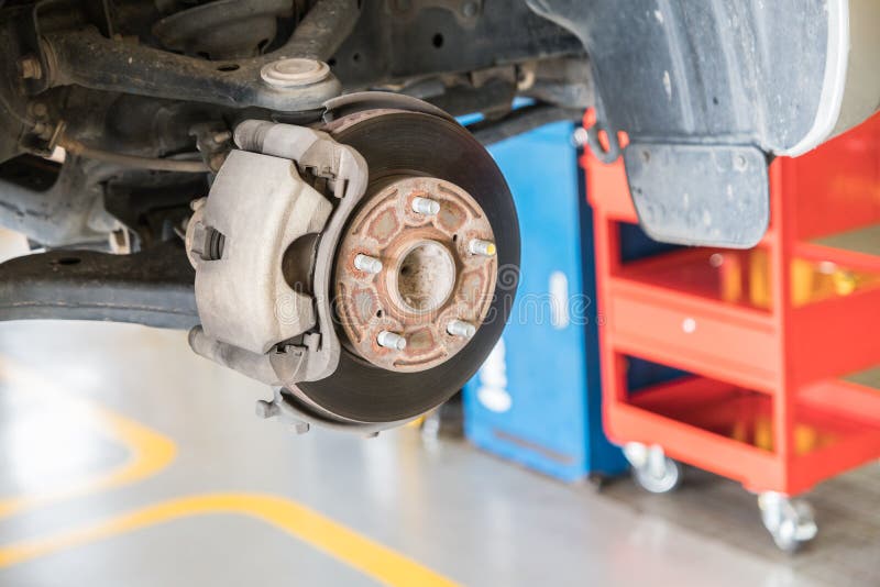 Front Disc Brake on Car in Process of New Tire Replacement Stock Photo