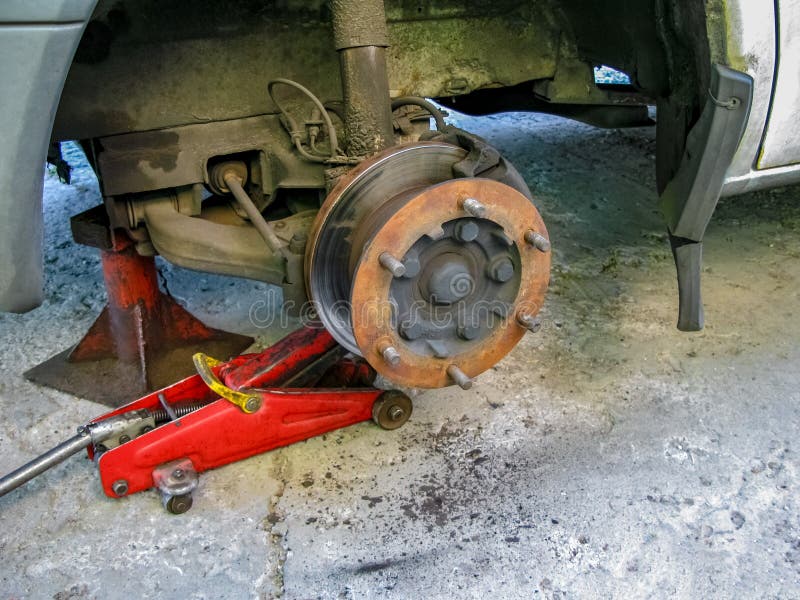 Front Disc Brake on Car in Process of New Tire Replacement Stock Image