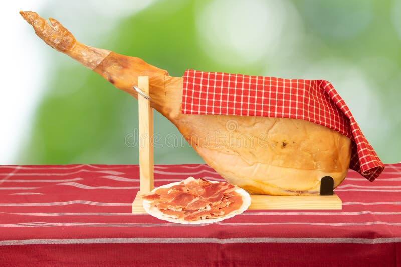 A Front Leg Of A Spanish Serrano Ham On Red Striped Tablecloth A Stock Image Image Of Snack