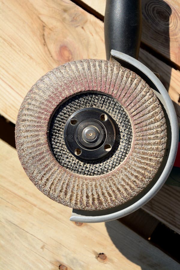 Front Part of Angle Grinder with Abrasive Disc on Planks Stock Image