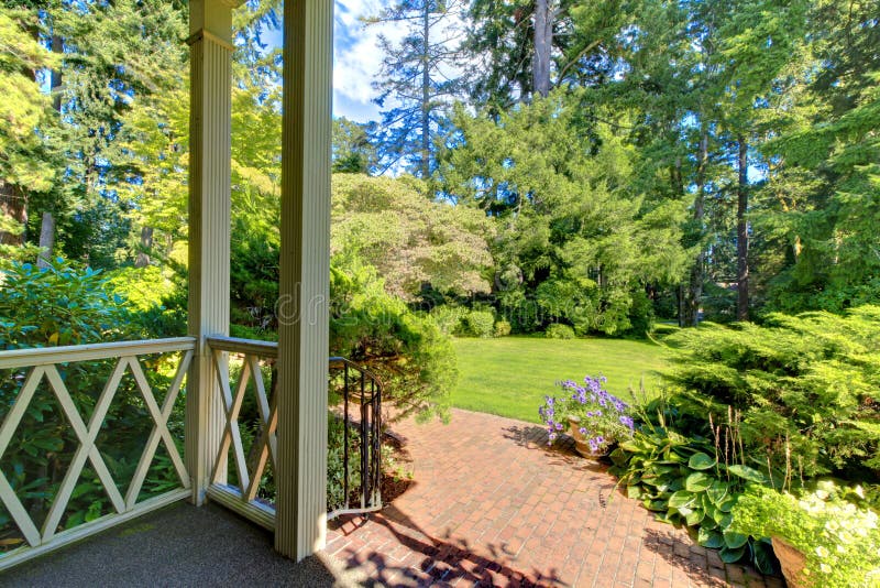 Front porch house exterior with summer garden.