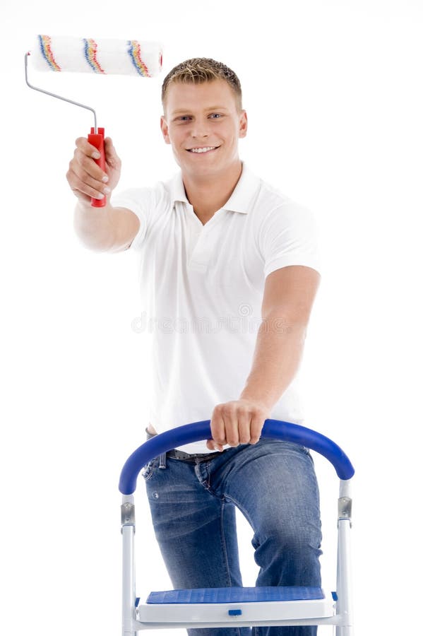 Front pose of smiling male holding brush royalty free stock photo