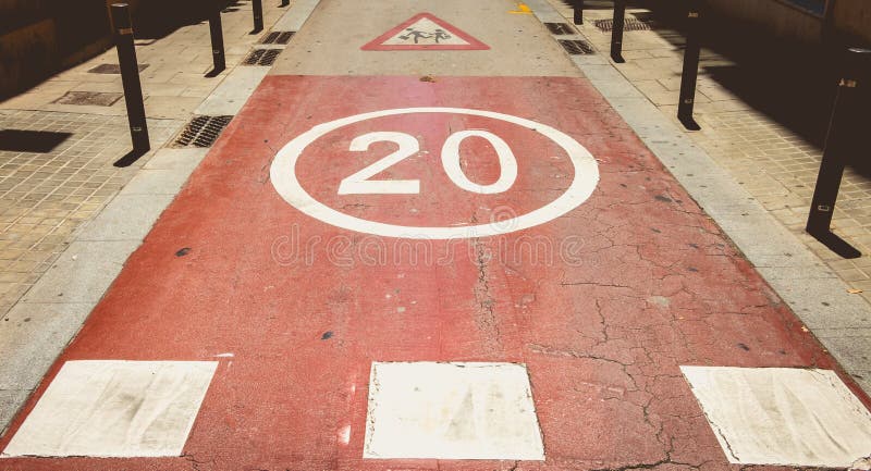 In front of a pedestrian crossing, white paint forbidden to exceed the speed of 20 stock images