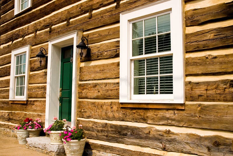 Front of restored log house stock image Front of restored log house stock image