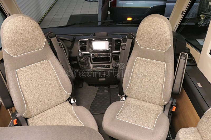 Front seats turned backwards into dining position in modern premium german camper van Carthago Malibu 450 Light, displayed on Caravan Bike Travel expo in Nitra, Slovakia, february 2026