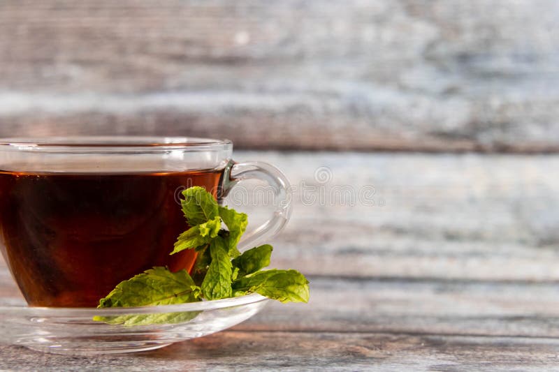 Front Shot of Black Tea and Mint Leaves with Defocused Background and