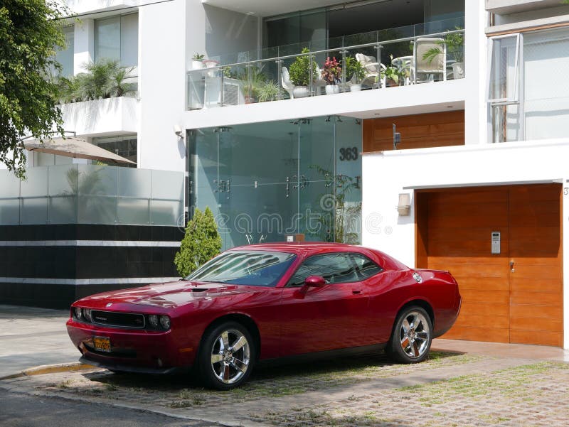 Front and side view of a red mint condition Dodge Challenger SRT8 392 Hemi parked in Miraflores, Lima stock photo