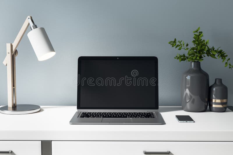 Front view on blank black laptop display on white table with stylish vase, lamp and smartphone. Mockup royalty free illustration