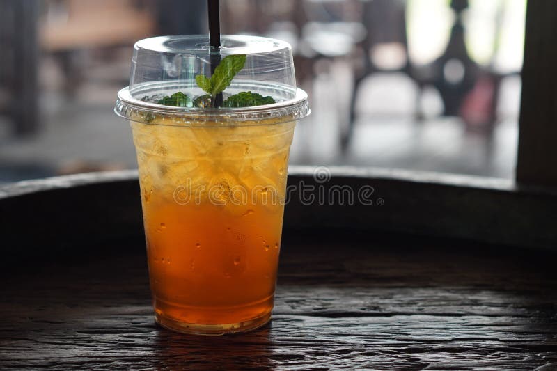 Premium Photo  Ice tea with slice of lemon in plastic cup on the wooden