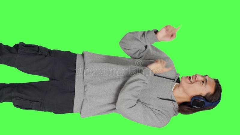 Front view of model listening to music and dancing stock footage