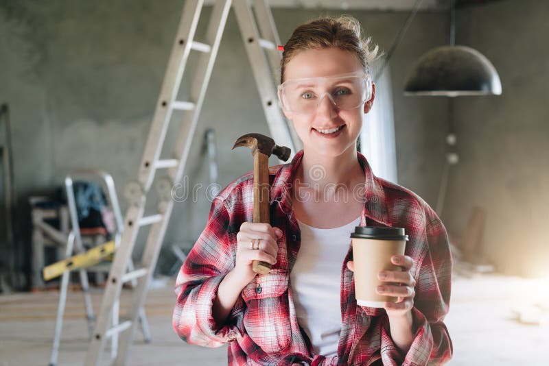 Front view. Portrait of happy young female construction worker