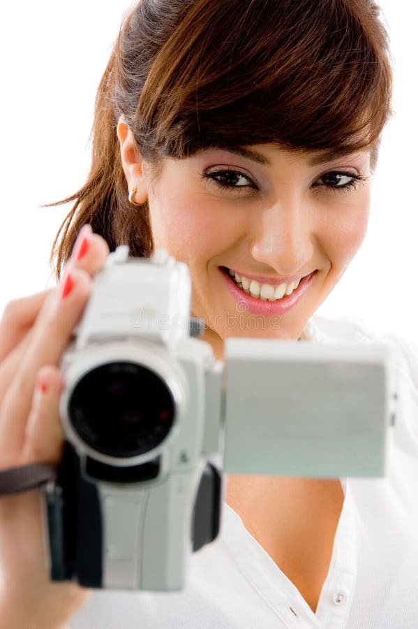 Front view of smiling female holding video camera