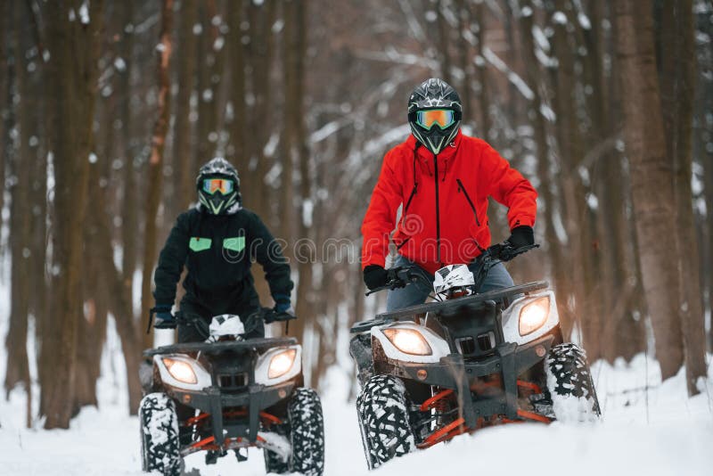 Front View. Two People are Riding ATV in the Winter Forest Stock Image
