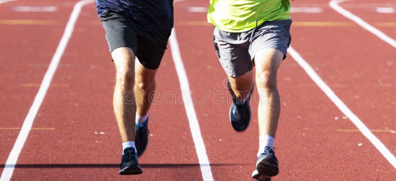 Front View of Two Runners Side by Side on a Track in Sunshine Stock ...