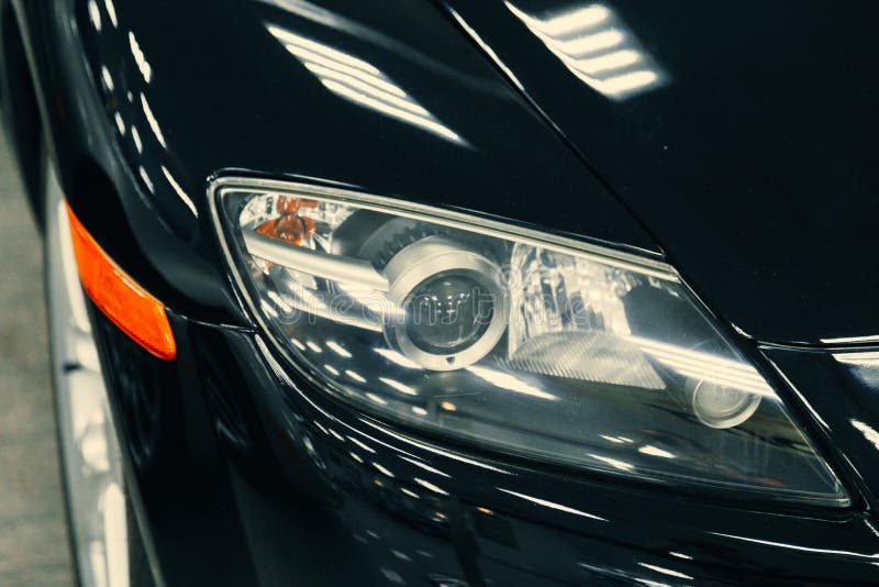 Front Xenon Turning Headlights of Modern Car in Garage Stock Image