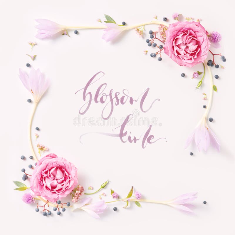Lettering -Blossom time written in calligraphy style on paper with wreath frame with roses isolated on white background. flat lay, overhead view, top view. Lettering -Blossom time written in calligraphy style on paper with wreath frame with roses isolated on white background. flat lay, overhead view, top view