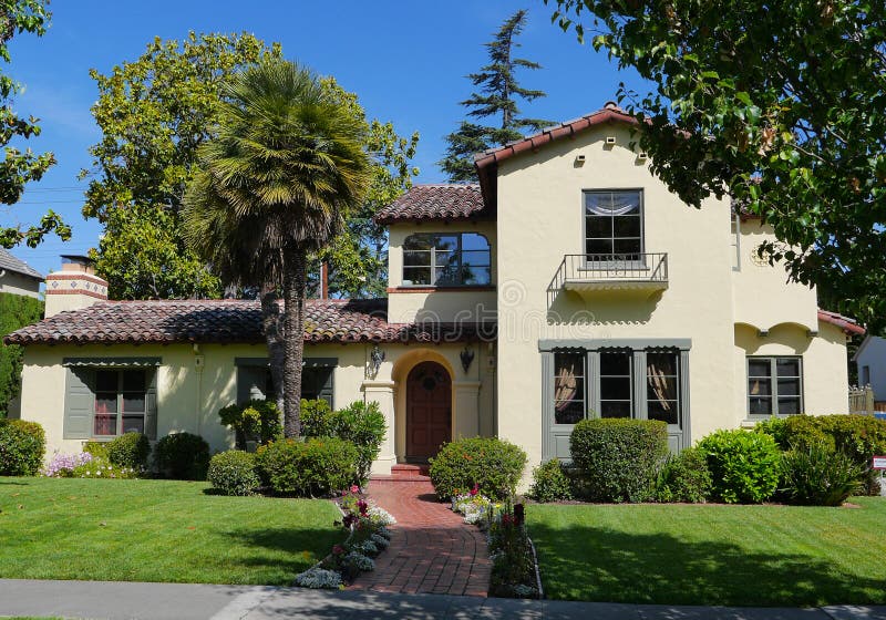 Luxury house with green lawn frontyard roof with adobe shingles. Luxury house with green lawn frontyard roof with adobe shingles