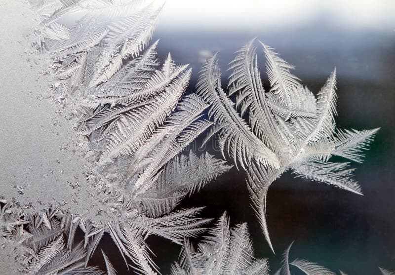 Frost draws ice background patterns on a windowpane stock photography