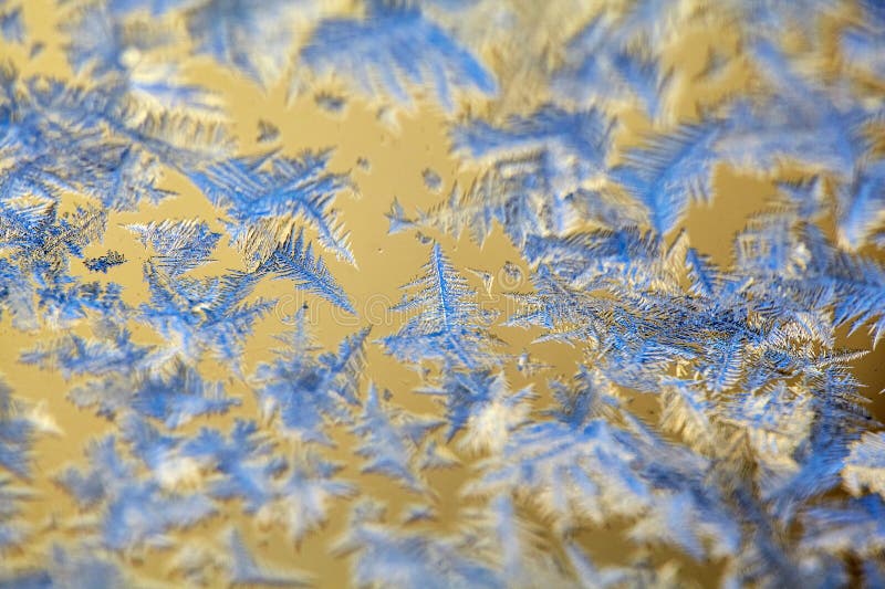 Frost Patterns: Abstract Ice Formations on a Window. Detailed shot highlighting the contrast between the frosty patterns and the royalty free stock photo