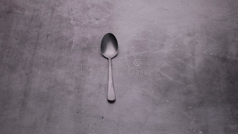 Frosted Spoon is Spinning on the Table, a Video of Cutlery on a